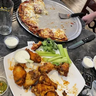 40 wings and an awesome pizza. Would have take. It home but flying home.