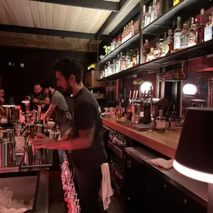  bartender preparing a drink at a bar