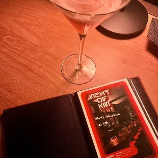  book and a martini glass on a table