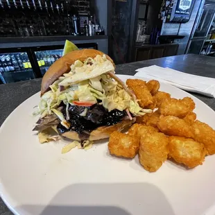 Smoked Korean bbq sandwich with spicy apple coleslaw,drizzled with black garlic Bulgogi sauce and a pleasant side of Taters!!!