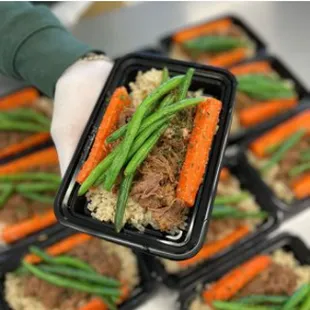 a person holding a tray of food