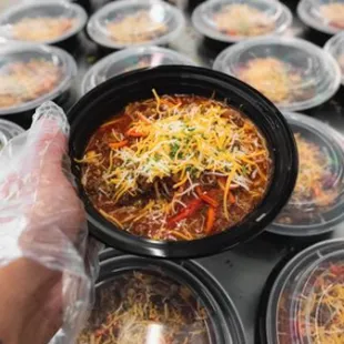 a bowl of chili and cheese