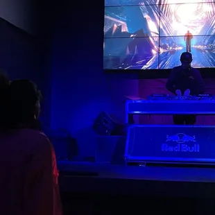 a man playing a video game on a big screen