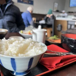 a bowl of rice and a bowl of soup on a tray