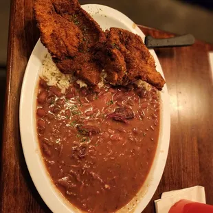 Pork chop dinner with red beans and rice.