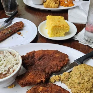 Pork chops and cornbread dressing, red beans, and rice with a side of sausage. My wife had the fish and shrimp.
