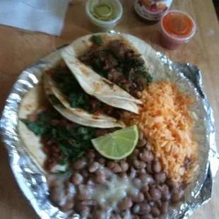 Three Tacos, beans and rice $4.75