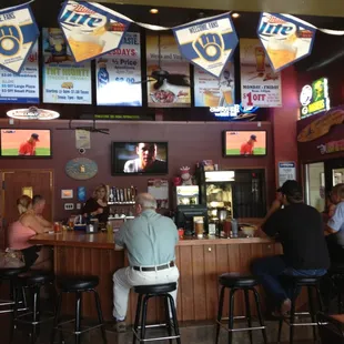 Pic of the bar w the tvs and specials hanging above