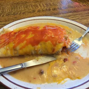 Bacon breakfast burrito with some hot sauce