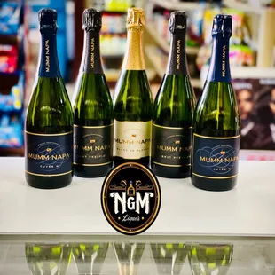 a row of bottles of sparkling wine