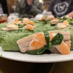 a plate of sushi wrapped in lettuce