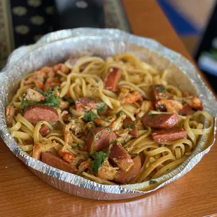CRAWFISH PASTA, chunky crawfish meat, spicy sausage, house tomato cream marinara sauce