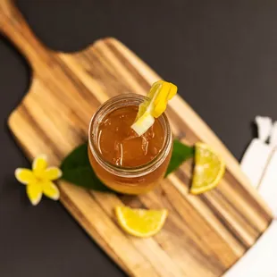 a jar of iced tea on a cutting board
