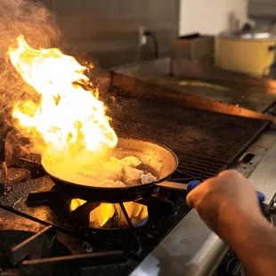 a person cooking food on a stove