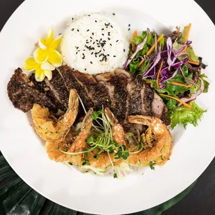 a plate of food with shrimp, rice and vegetables
