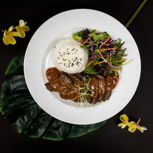 a plate of food with rice and meat