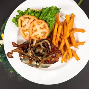 a white plate with a burger and french fries