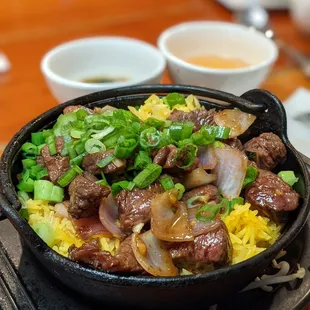 Clay Pot with rice and marinated steak. A tasty and well portioned dish. The two sauces are bomb and must be used.