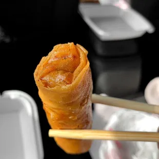 a person holding a pair of chopsticks