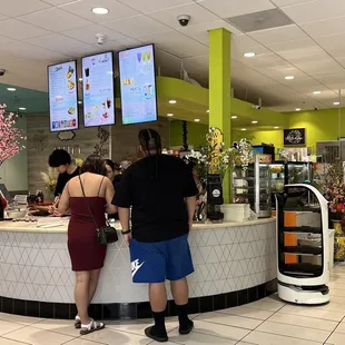 a couple of people standing at a counter