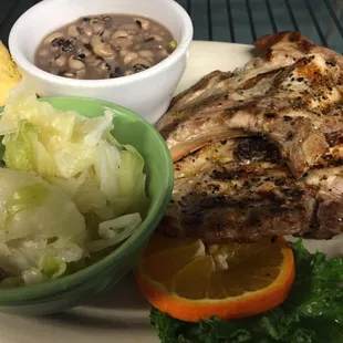 Grilled porkchop, cooked cabbage &amp; black eyed peas