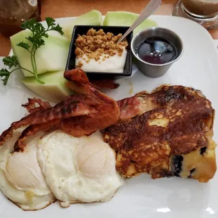 The special of the day: A slice of French Toast-battered cake, two eggs cooked your way, bacon, and yogurt &amp; granola