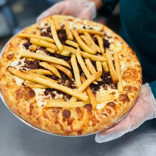 a person holding a pizza