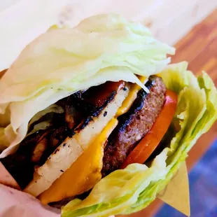 a hand holding a hamburger