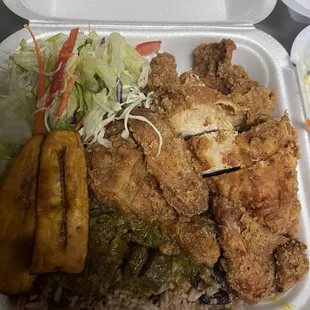 Juicy fried chicken sever with curry goat gravy and rice and peas