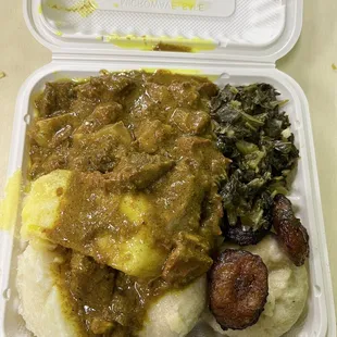 Curry goat, dumplings, half spinach and half plantains.