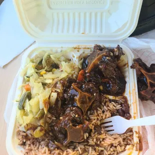 Ox tail stew w/ rice n peas and cabbage. I had already had a few bites before taking the pic.