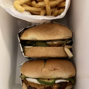 three burgers and french fries