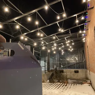 the outside of a building with string lights