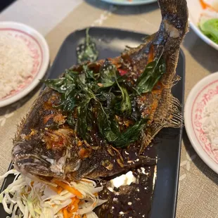 Three flavor fried flounder fish, topped with fried spinach - a must!