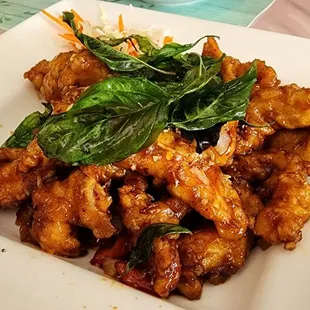 Crispy Garlic Chicken: stir fried with house special garlic sauce, bell peppers, onions; fried basil