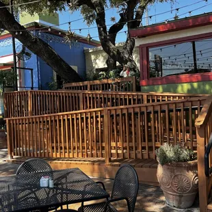 a patio with tables and chairs