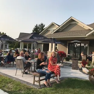 a group of people sitting outside of a restaurant