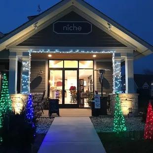 the front of a home decorated for christmas