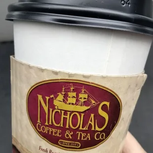 a hand holding a cup of coffee
