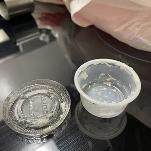 The TINY container they give you of the toum and tzatziki that comes with your dish.