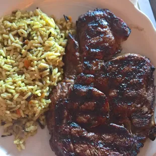 a plate of meat and rice