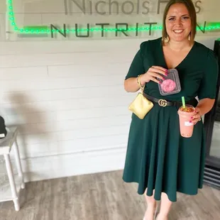 a woman standing in front of a neon sign