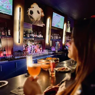 a woman holding a glass of beer