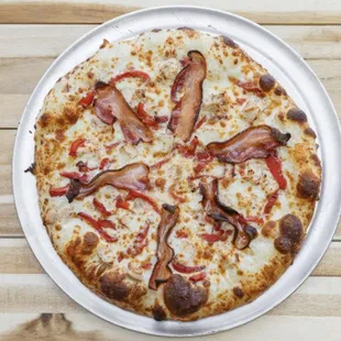 Chicken Bacon Alfredo Pizza! That's right a whole slice of bacon per piece!