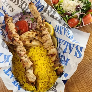 Chicken skewer meal with salad and rice