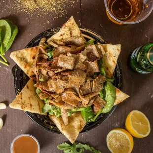 a plate of pita chips and a glass of beer