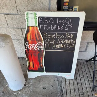 a chalk board with a coca cola sign