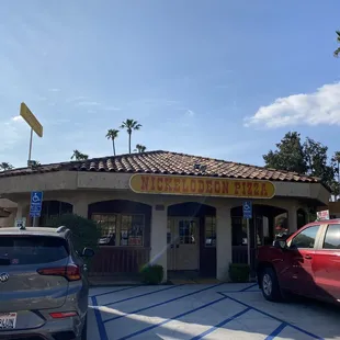 two cars parked in front of a restaurant