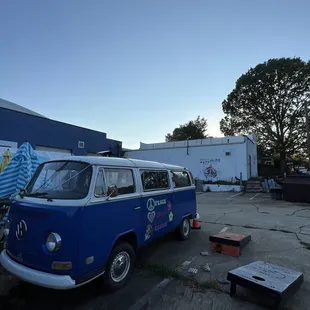 a blue vw bus parked in a parking lot