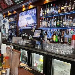 a bar with a lot of bottles of alcohol